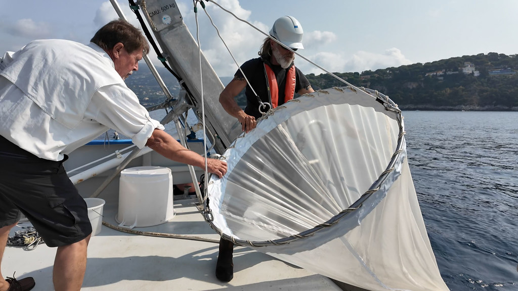 Jean-Yves Carval (left), captain of the Sagitta III, and his chief mechanic, Christophe Kieger, fish zooplankton with a special net.